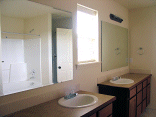 The master bathroom with mirrors installed.