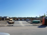 The exterior concrete and driveway are done. Look at all the building materials ready to go up.