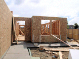 Front of the house, living room windows and front door.