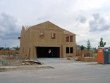 The roof trusses are all up with the entire second floor framed up.